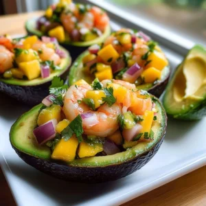 Avocado shrimp dish topped with colorful mango salsa on a plate