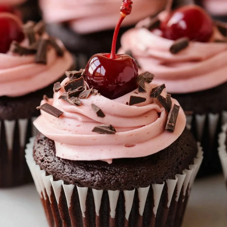 Delicious cherry chocolate cupcakes topped with cherry frosting and chocolate sprinkles