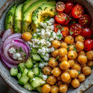 Colorful Chickpea Feta Avocado Salad with fresh vegetables and dressing