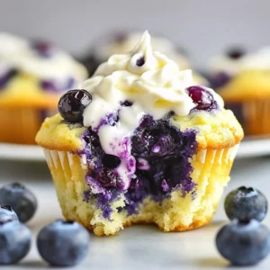 Cream cheese blueberry streusel muffins on a plate with fresh blueberries