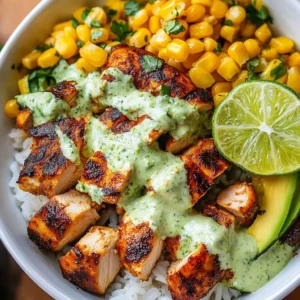 Smoky street corn chicken bowls garnished with fresh herbs in a colorful bowl