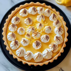 A delicious triple layer lemon meringue cheesecake with golden meringue on top.